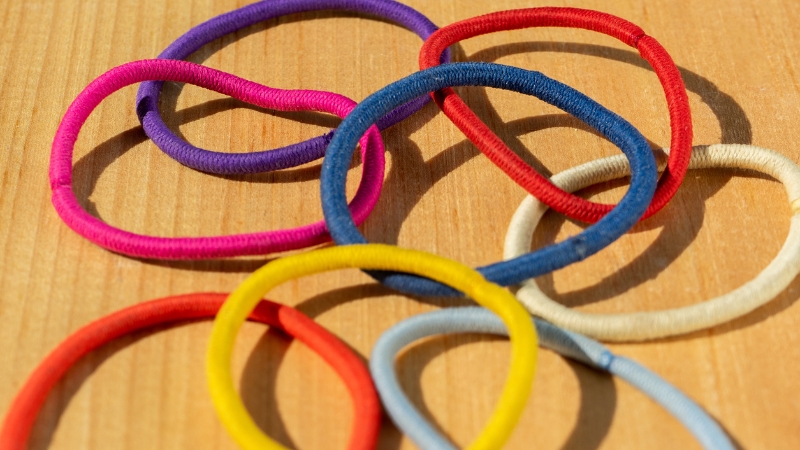 Colorful hair elastics, some with metal parts that can snag and break hair strands