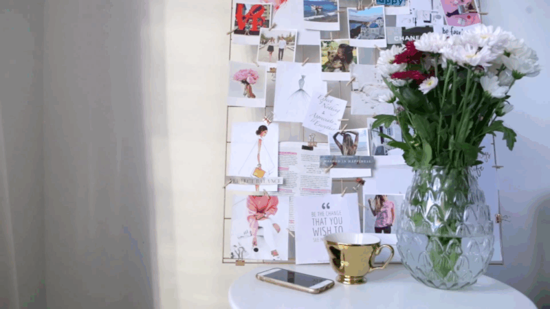 Vision board with photos and quotes next to flowers and a cup, showing vision boards for life after 50
