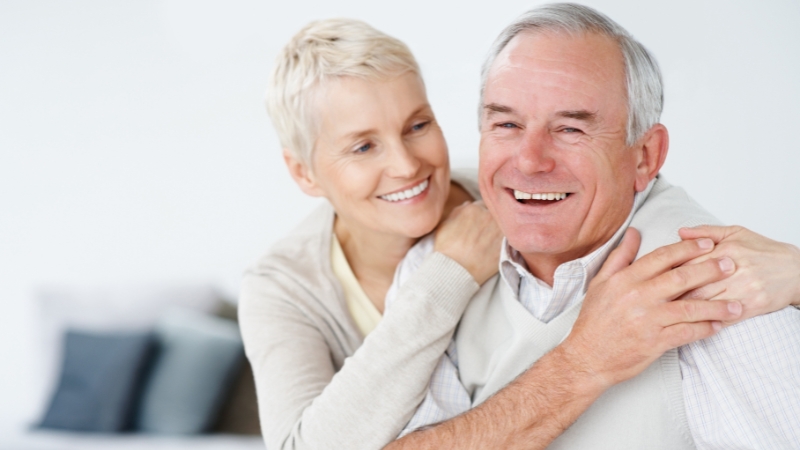 Smiling older couple embracing, showing confidence and joy after a divorce