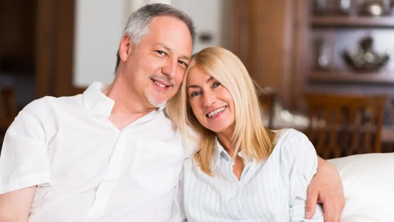 Happy couple sitting together, showing finding love again after divorce in your 50s