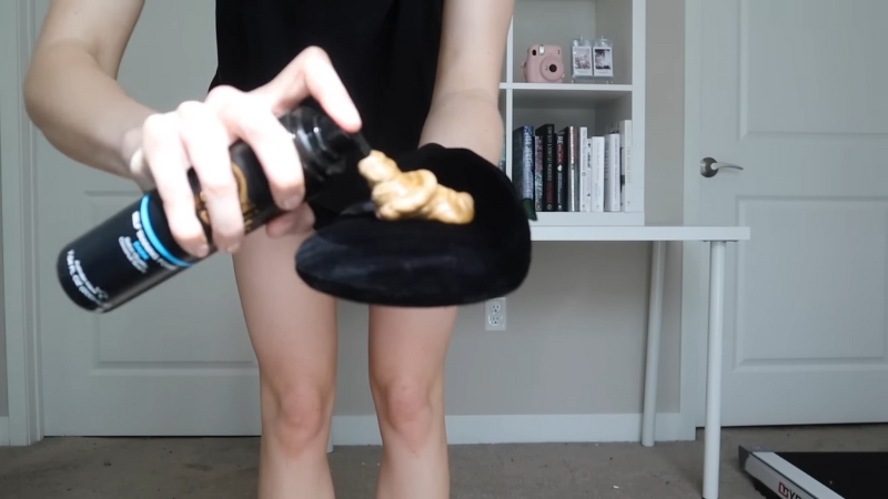Person dispensing self tanner mousse onto an applicator mitt before use