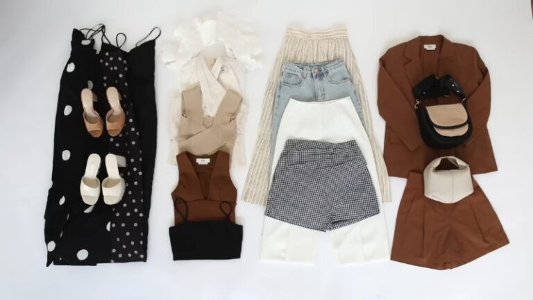 A capsule wardrobe flat lay with dresses, tops, jeans, shorts, blazers, shoes, and bags neatly arranged
