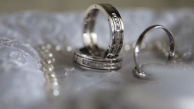 Platinum rings with diamonds placed on soft fabric for a close-up jewelry shot